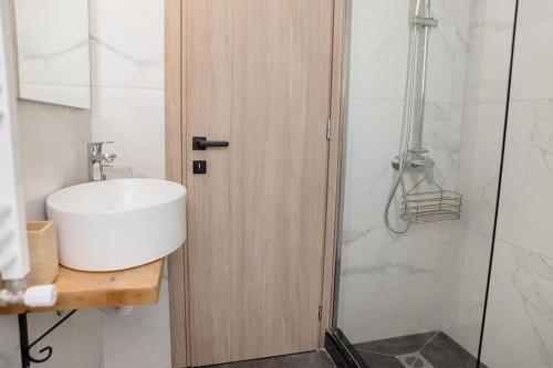 a bathroom with a sink and a shower at Debbie's διαμέρισμα δίπλα στο νερό ! in Chalkida