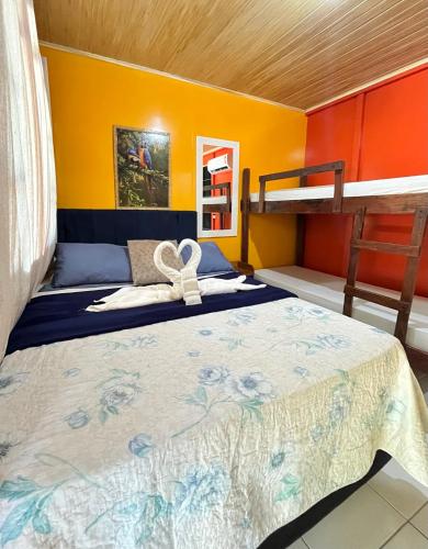 a bedroom with a bed and a bunk bed at Pousada & Camping Tubarão in Ilha do Mel