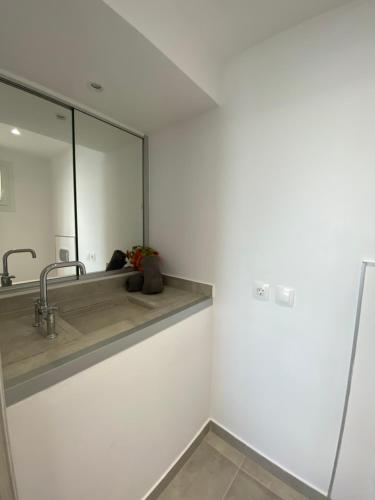 a bathroom with a sink and a mirror at RIZARIA sea view house in Spartýlas