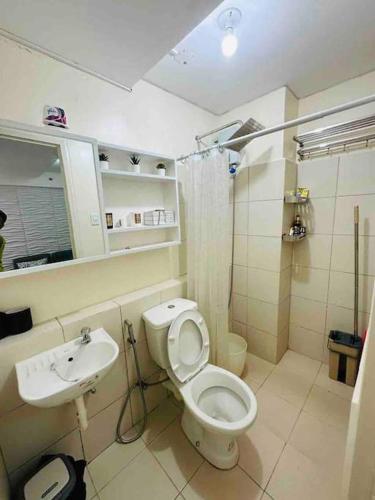 a bathroom with a toilet and a sink at Condo in Ortigas (Kimea Suite) in Manila