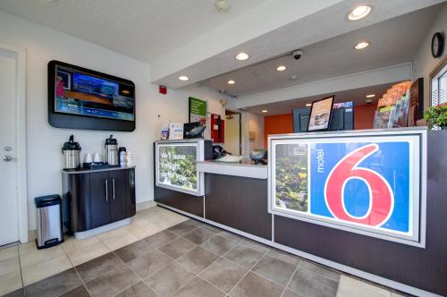 a gas station with a sign on the wall at Motel 6-Seattle, WA - Airport in SeaTac
