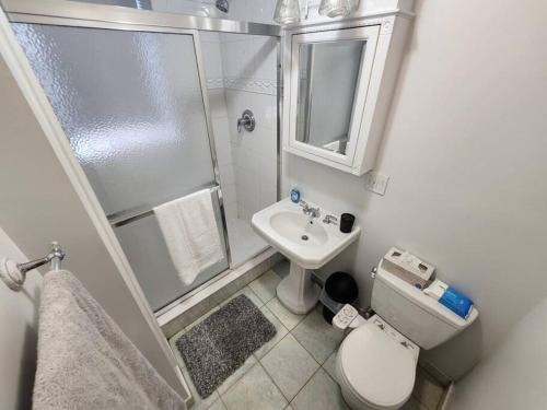 a small bathroom with a shower and a toilet and a sink at Spacious 3 bedroom apartment mins to NYC! in Union City