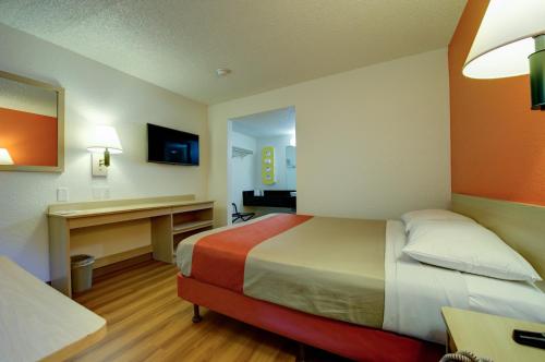 a hotel room with two beds and a desk at Motel 6-Seattle, WA - Airport in SeaTac