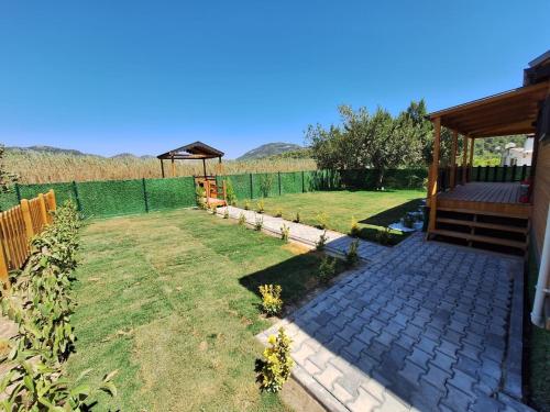 a backyard with a gazebo and a lawn at Lake House Kayacık in Dalaman
