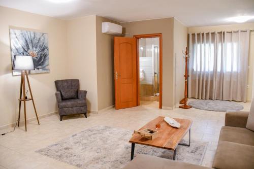 a living room with a couch and a table at Toula Rooms in Ángistron