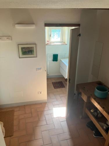a room with a bathroom with a window and a table at Podere La Croce Toscana in Solata