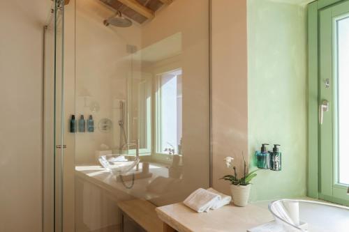 a bathroom with two sinks and a glass shower at Hidden Dalla Gioconda in Gabicce Mare