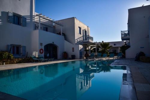 a swimming pool in front of a building at Aphrodite sunshine suite in Mýkonos City