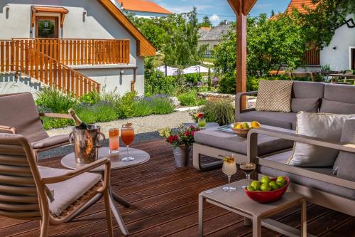 a patio with a couch and chairs and a table with drinks at Mandilla in Köveskál