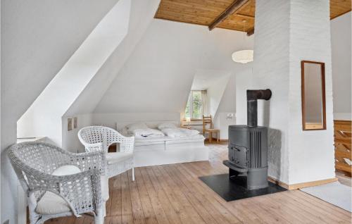 a living room with a wood stove and a couch at 2 Bedroom Beautiful Home In Ringe in Ringe