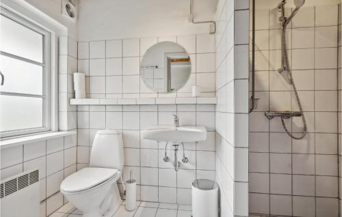 a white bathroom with a toilet and a sink at 2 Bedroom Beautiful Home In Ringe in Ringe