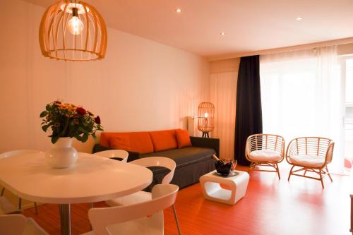 ブランケンベルヘにあるResidentie Alfa Inn***のリビングルーム(ソファ、テーブル、椅子付)