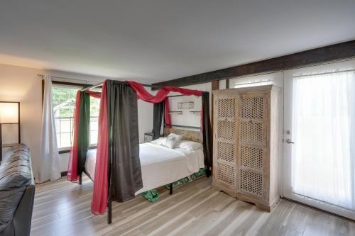 a bedroom with a bed with a canopy in it at Pet-Friendly Caneadea Retreat with Deck! in Oramel