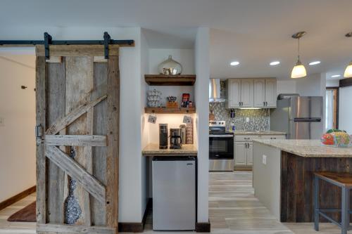 a kitchen with a sliding barn door in a kitchen at Pet-Friendly Caneadea Retreat with Deck! in Oramel