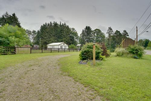 a dirt road in a yard with a fence at Pet-Friendly Caneadea Retreat with Deck! in Oramel