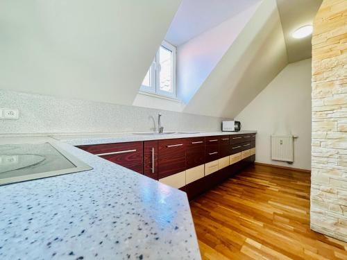 a large kitchen with a counter and a sink at Central Apartment Fun & Teambuilding in Košice