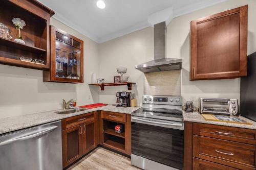 a kitchen with wooden cabinets and a stove top oven at Loft Apt with Balcony in the Heart of Kennett Square in Kennett Square