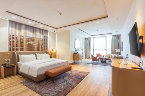 a hotel room with a bed and a living room at Silk Road by Minyoun in Samarkand