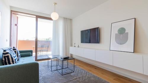 a living room with a couch and a tv at Modern and Spacious 1BR in Gaia by LovelyStay in Vila Nova de Gaia