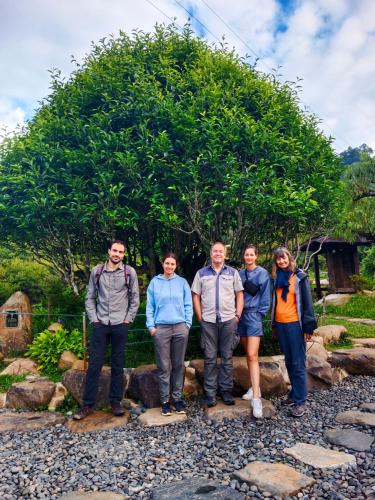 a group of people standing in front of a tree at homestay phô núi suôi giang in Yên Bái