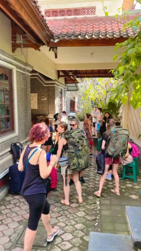 a group of people standing outside of a building at Genta House in Kuta