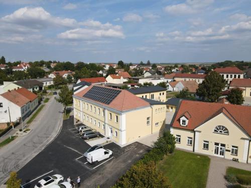 an aerial view of a town with a building with solar panels at Weinlandmotel in Ebenthal