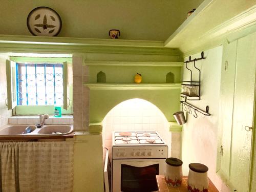 a kitchen with a stove and a sink and a oven at Chroma Kastellorizo in Meyisti