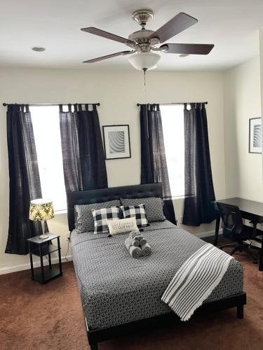 a bedroom with a bed with a ceiling fan at Cozy Home located in a prime area. in Philadelphia