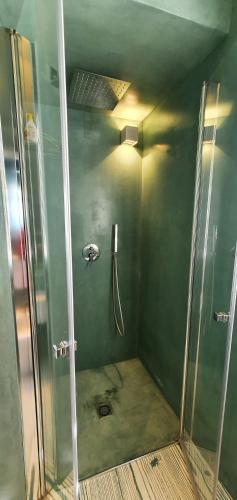 a shower with a glass door in a bathroom at TramontanaBeach in Tracino