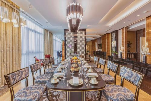 a long dining room with a long table and chairs at Silk Road by Minyoun in Samarkand