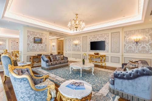 a large living room with furniture and a tv at Silk Road by Minyoun in Samarkand