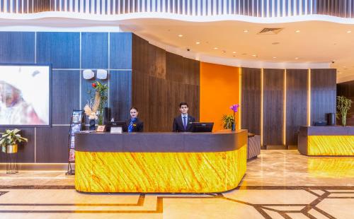 two people at a reception desk in a lobby at Silk Road by Minyoun in Samarkand