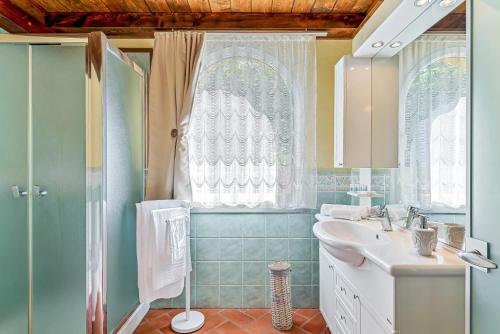 baño con lavabo y ducha con ventana en Casa vacanze Ester en Polverara