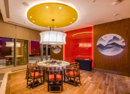 a dining room with a round table and chairs at Silk Road by Minyoun in Samarkand
