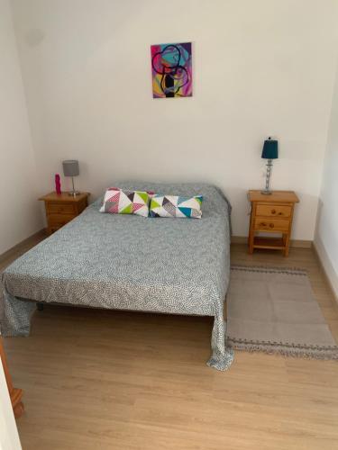 a bedroom with a bed with two pillows on it at Las Casas Rurales de Los Olivos in Tabernas