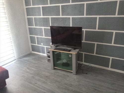 a computer monitor sitting on top of a table at Apartman Kujovic in Sarajevo
