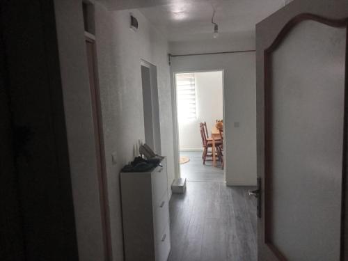 a hallway leading to a living room with a table at Apartman Kujovic in Sarajevo