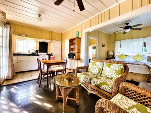 a living room with a couch and a table at Waimea Plantation Cottages, a Coast Resort in Waimea