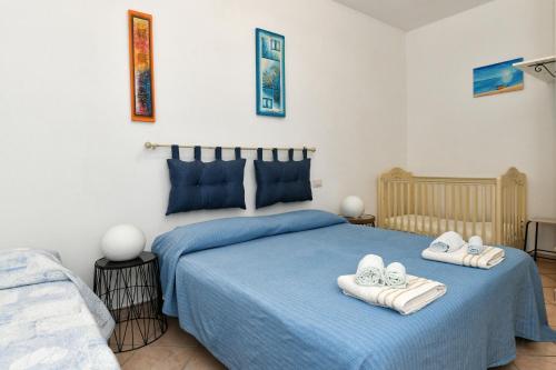 a bedroom with a blue bed with towels on it at My Opera Private Pool by Sarda Bella in Rudalza