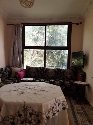a living room with a couch and a window at Ouirgane marrakech lhawz in Agouni