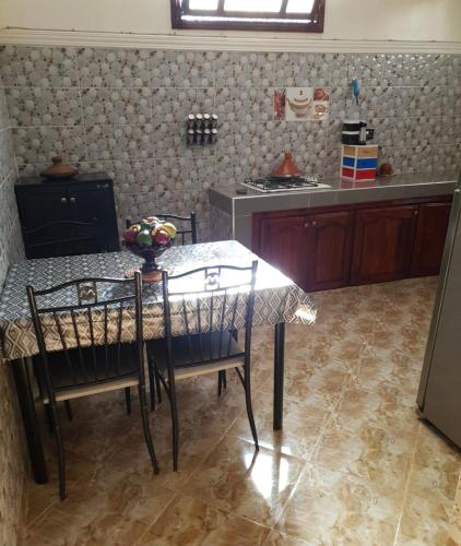 a kitchen with a table and chairs in a kitchen at Ouirgane marrakech lhawz in Agouni