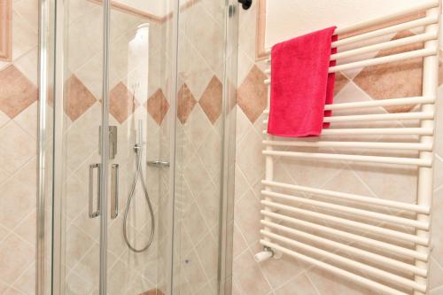 a bathroom with a shower and a red towel at My Opera Private Pool by Sarda Bella in Rudalza