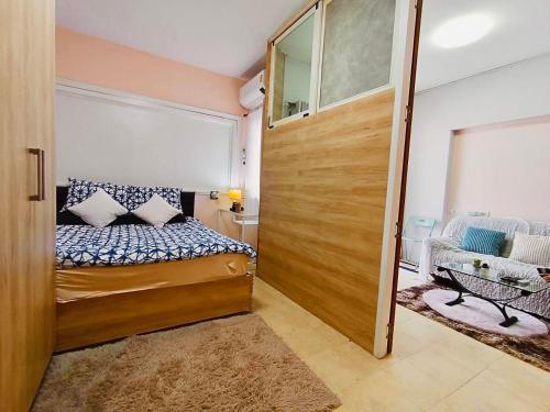a small bedroom with a bed and a sliding door at Cozy 1br walk to BTS and Airport Rail Link Close to Malls T in Bangkok