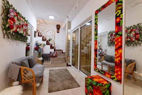 a living room with flowers on the walls at Negrean Residence in Oradea