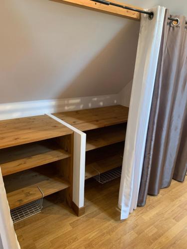 a staircase with wooden shelves in a room at Gîte Bien-être in Yquebeuf