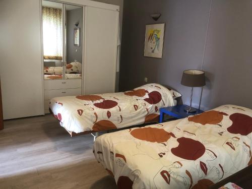 a bedroom with two beds with cows on them at Laaker Villa nearby outlet Roermond in Ohé en Laak