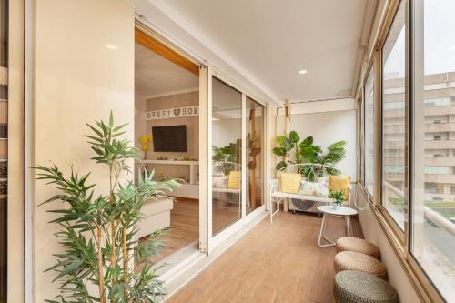 an apartment with a balcony with plants and a tv at Apartamento Girassol - Minho's Guest in Braga