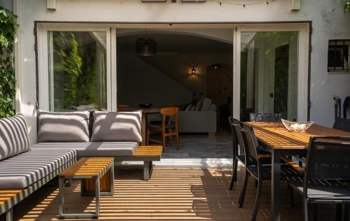 a patio with a couch and a table and chairs at Luxury townhouse capricho golden mile in Marbella