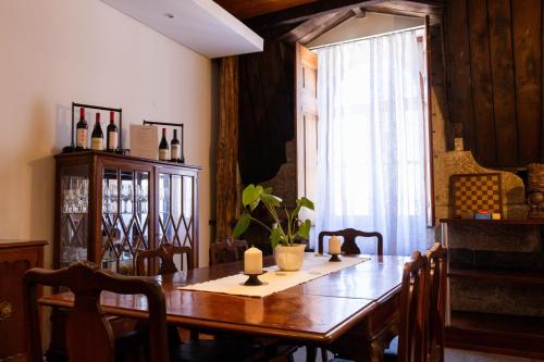 a dining room with a wooden table and a window at Fradelos Porto Centro in Porto