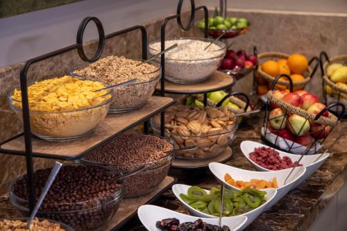 a display of different types of food in bowls at Hilly Hotel in Edirne